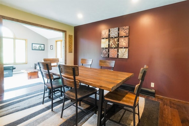 dining space featuring lofted ceiling, a baseboard radiator, baseboards, recessed lighting, and wood finished floors