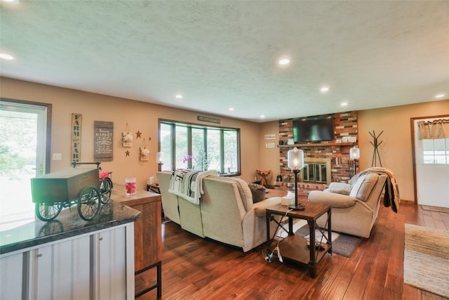 living room featuring recessed lighting, dark wood-style flooring, and a wealth of natural light
