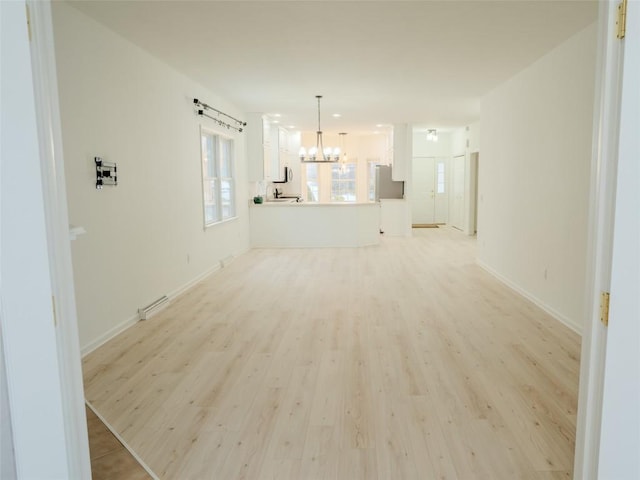 interior space with a chandelier and light wood-type flooring