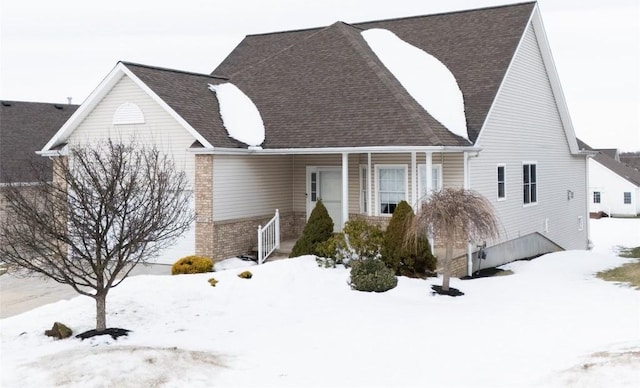 view of snow covered rear of property