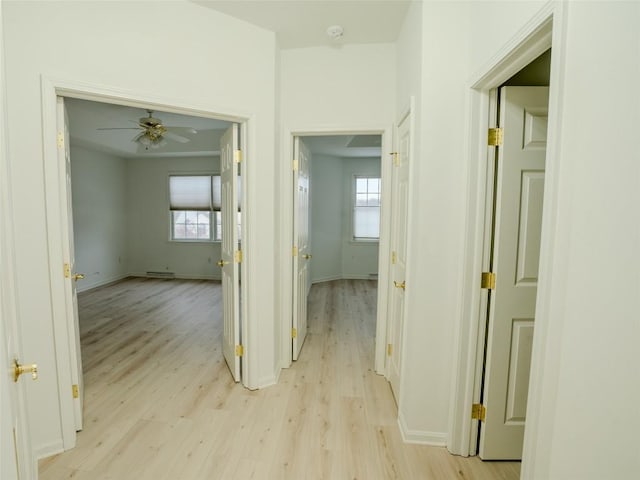 hallway with light hardwood / wood-style flooring