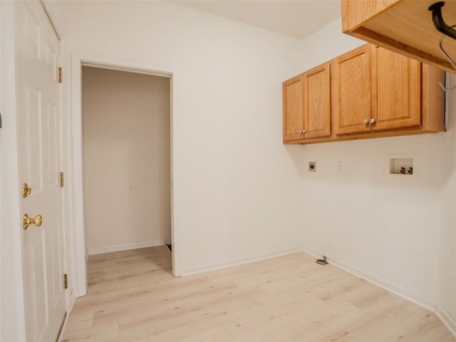 laundry area with hookup for a washing machine, cabinets, hookup for an electric dryer, and light wood-type flooring