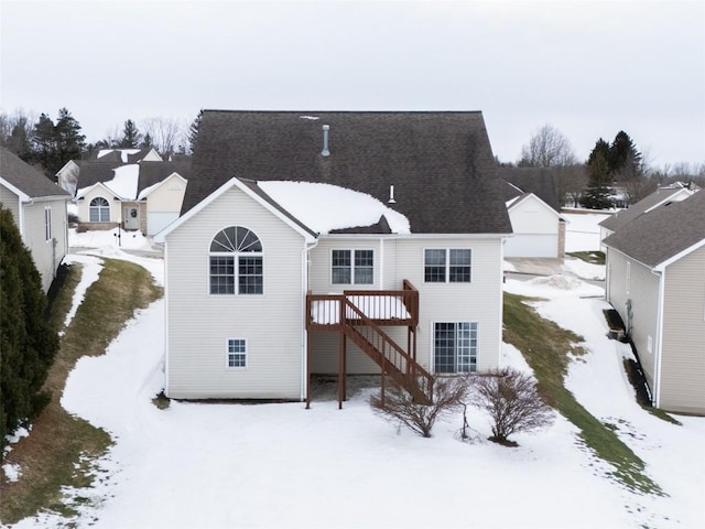 snow covered property featuring a wooden deck