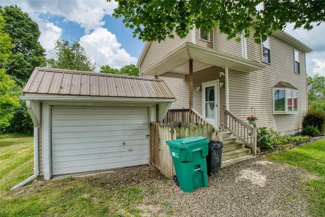 13151 Water Ext, Edinboro, PA 16412 - view of front of house with an outbuilding, a detached garage, a metal roof, and a front lawn