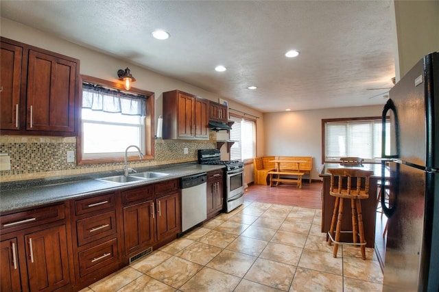 13151 Water Ext, Edinboro, PA 16412 - kitchen featuring stainless steel appliances, healthy amount of natural light, decorative backsplash, recessed lighting, and under cabinet range hood