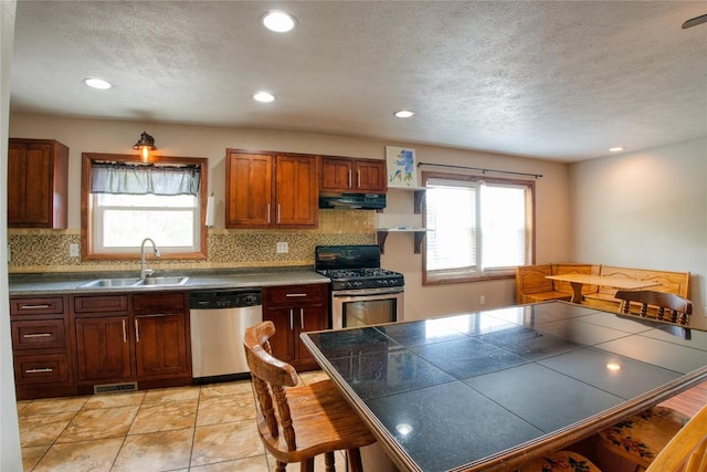13151 Water Ext, Edinboro, PA 16412 - kitchen with appliances with stainless steel finishes, under cabinet range hood, tasteful backsplash, recessed lighting, and a textured ceiling