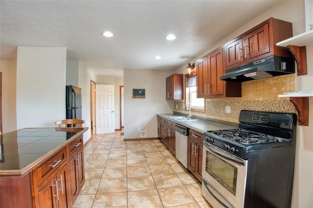 13151 Water Ext, Edinboro, PA 16412 - kitchen with appliances with stainless steel finishes, under cabinet range hood, tile counters, tasteful backsplash, and recessed lighting