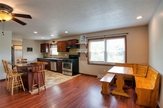 13151 Water Ext, Edinboro, PA 16412 - kitchen featuring stainless steel appliances, extractor fan, a ceiling fan, light wood-type flooring, and decorative backsplash