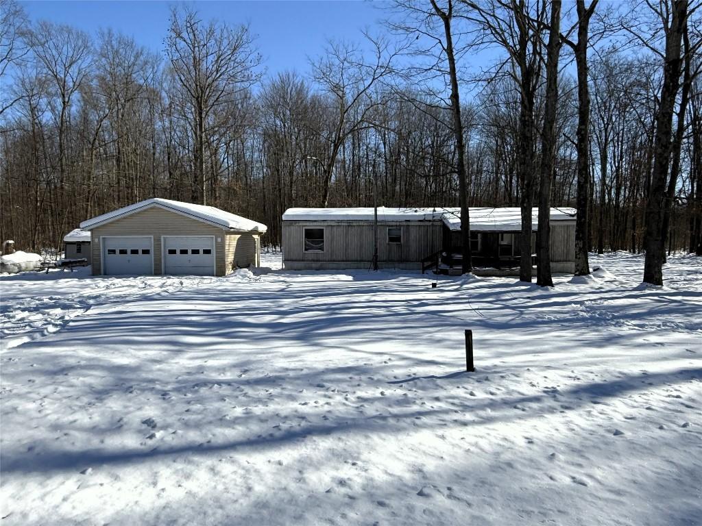 view of front facade featuring an outbuilding and a garage