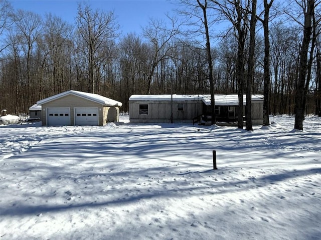 view of front facade featuring an outbuilding and a garage