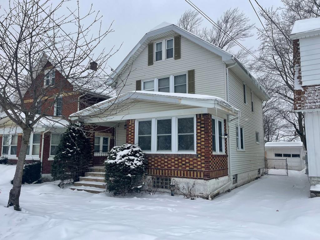 view of front of home featuring a garage and an outdoor structure