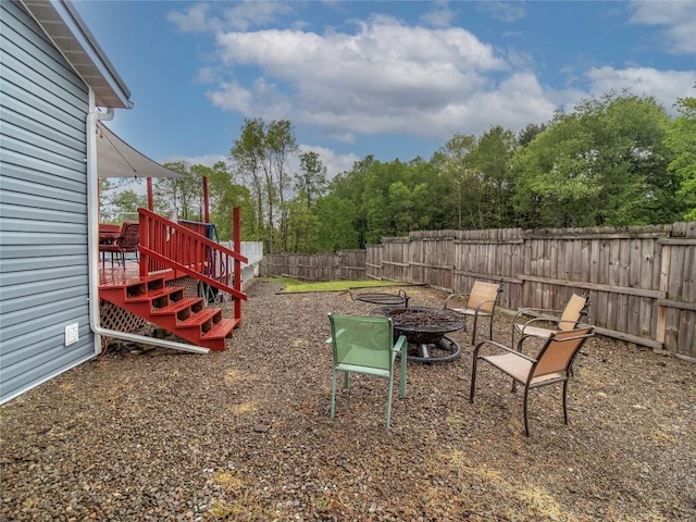 817 E Main St, Corry, PA 16407 - fenced backyard featuring an outdoor fire pit and a wooden deck