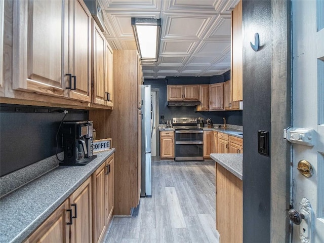 817 E Main St, Corry, PA 16407 - kitchen featuring appliances with stainless steel finishes, an ornate ceiling, under cabinet range hood, light wood finished floors, and brown cabinetry