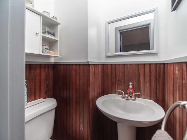 817 E Main St, Corry, PA 16407 - bathroom featuring a wainscoted wall, toilet, and wooden walls