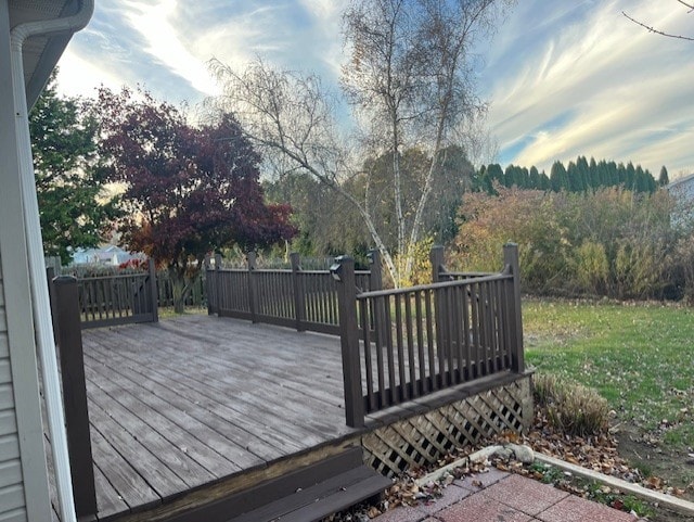 wooden terrace featuring a yard