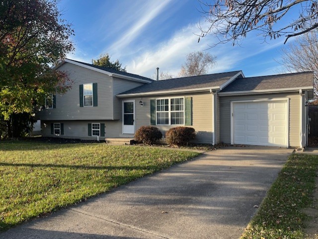 tri-level home with a front lawn and a garage