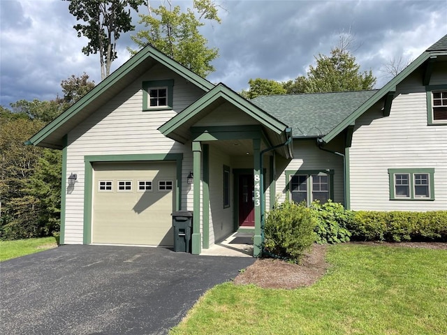 view of front of home featuring a garage and a front yard