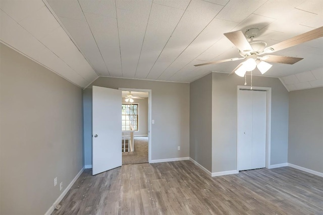 interior space with hardwood / wood-style flooring, vaulted ceiling, and ceiling fan