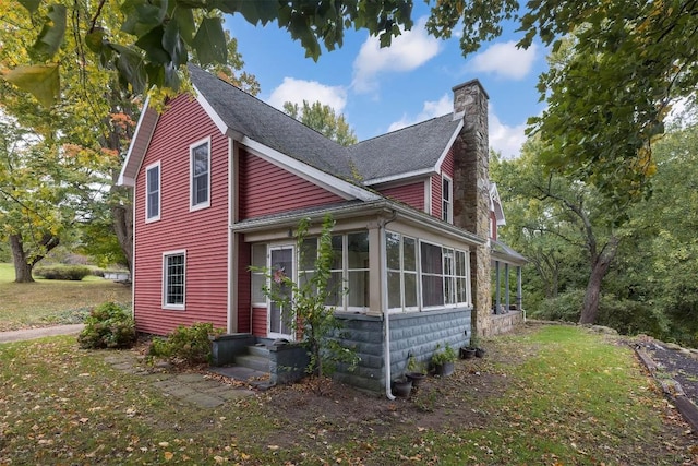 view of front of house featuring a sunroom