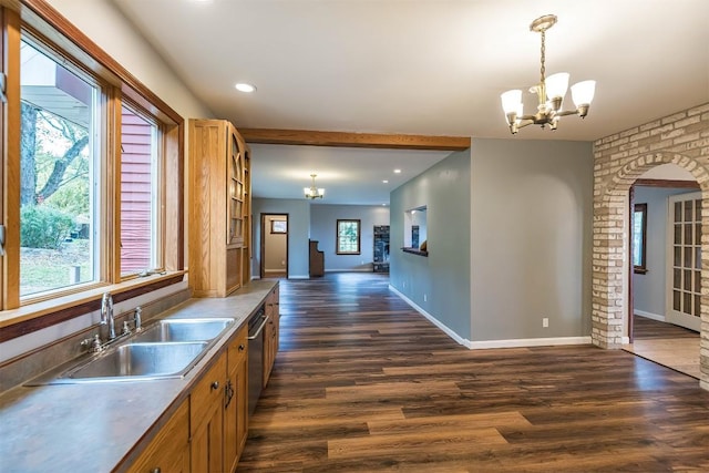 kitchen with dark hardwood / wood-style flooring, a healthy amount of sunlight, sink, decorative light fixtures, and an inviting chandelier