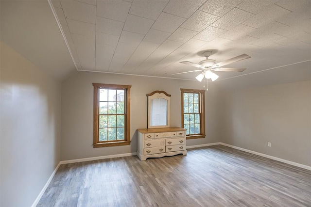 interior space featuring ceiling fan, lofted ceiling, and light wood-type flooring