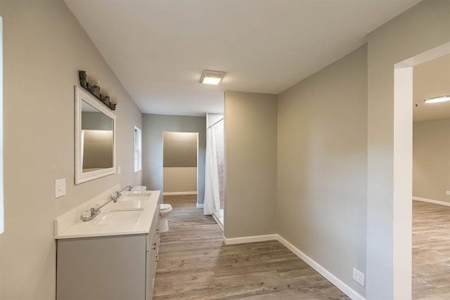 bathroom with vanity, toilet, and wood-type flooring