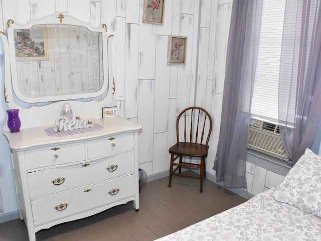 bedroom with dark hardwood / wood-style flooring and cooling unit