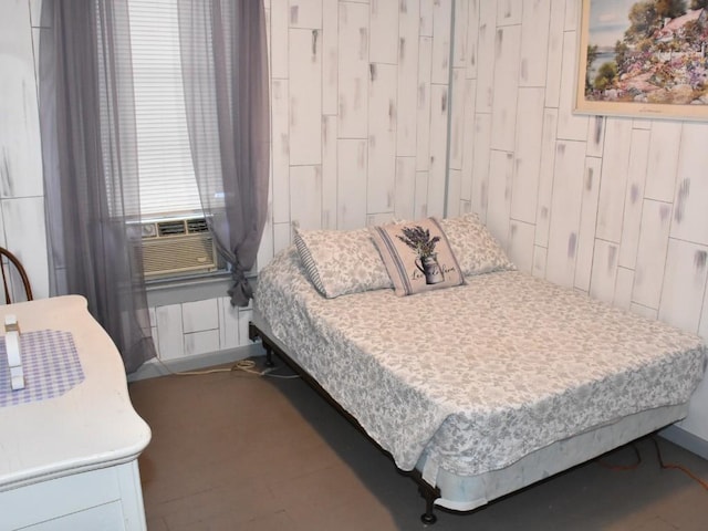 bedroom featuring radiator, wood walls, and cooling unit