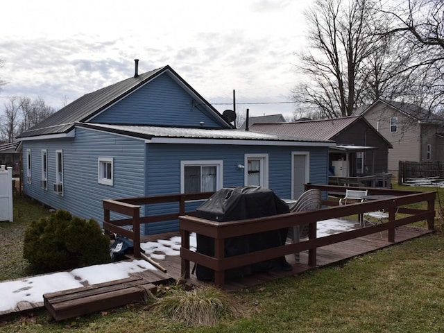 back of property with a wooden deck