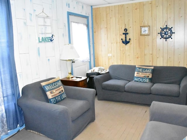 living room with wood walls and hardwood / wood-style flooring