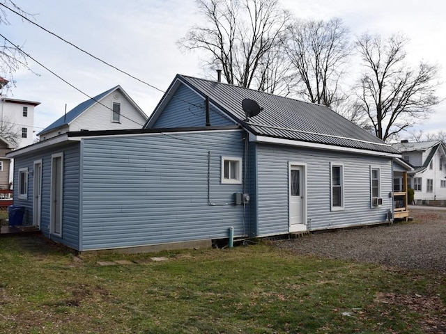 rear view of house featuring a yard