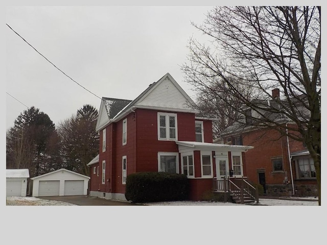 view of front of property featuring a garage and an outdoor structure