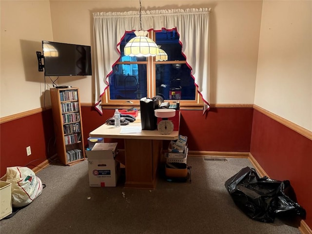 office space with wainscoting, visible vents, and baseboards