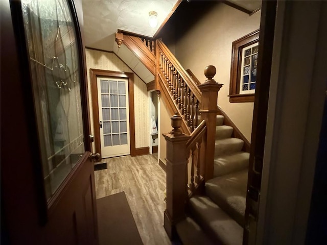 interior space featuring stairs, french doors, and wood finished floors