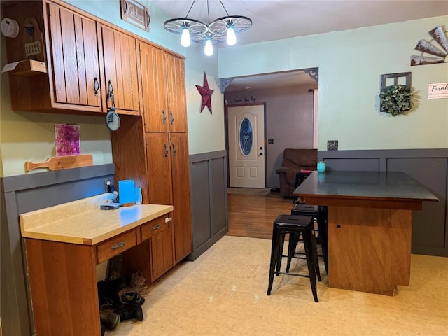 kitchen with hanging light fixtures, a chandelier, and a kitchen bar