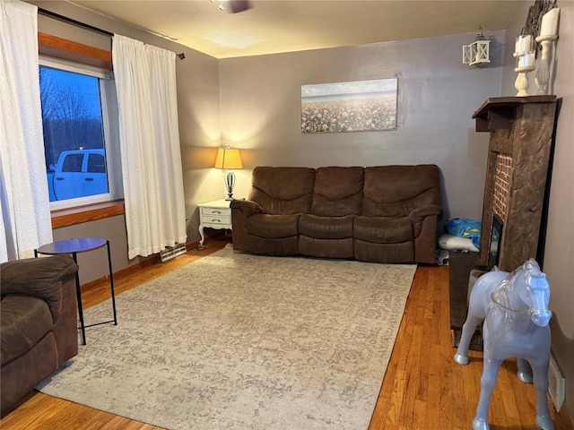 living room featuring a fireplace and hardwood / wood-style floors