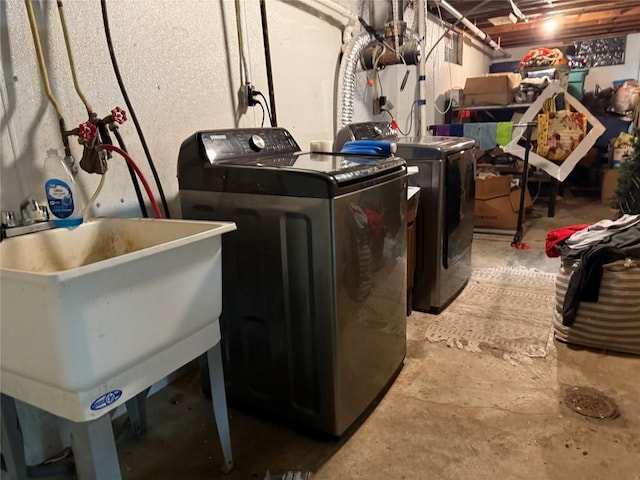 laundry area with washer and clothes dryer and sink