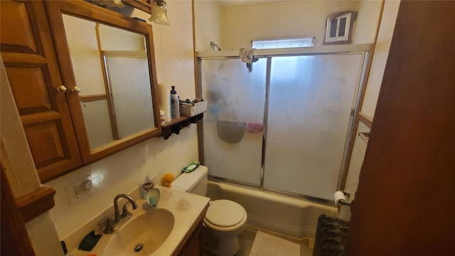 full bathroom featuring shower / bath combination with glass door, vanity, and toilet