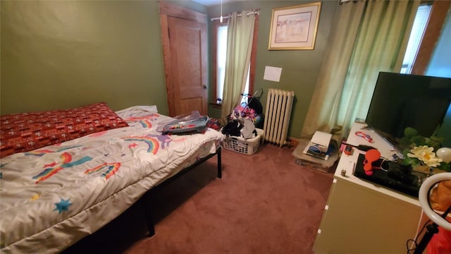 bedroom with carpet flooring and radiator heating unit