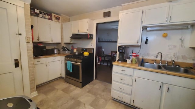 kitchen with white cabinetry, stainless steel range with gas cooktop, sink, and ornamental molding