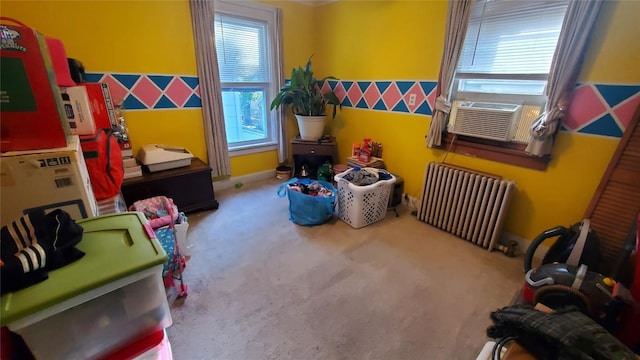 playroom featuring cooling unit, radiator heating unit, and carpet floors