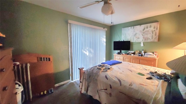 bedroom featuring ceiling fan and dark carpet