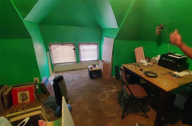 carpeted home office featuring vaulted ceiling