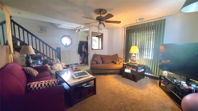 carpeted living room with ceiling fan