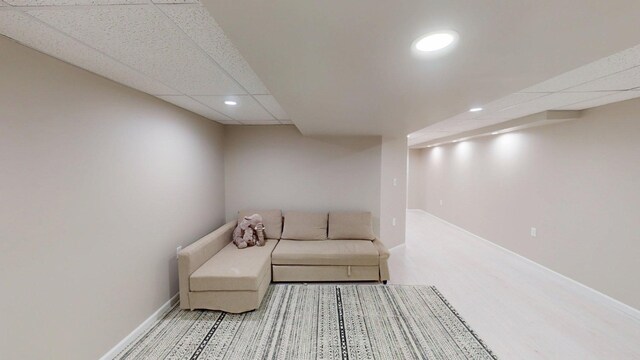 sitting room with recessed lighting, a drop ceiling, and baseboards