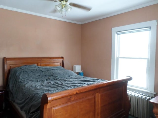 bedroom featuring ceiling fan, ornamental molding, and radiator heating unit