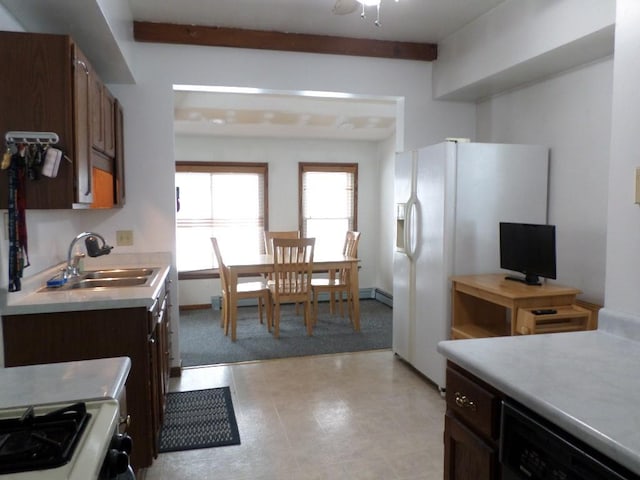 kitchen with dishwasher, light countertops, stove, and a sink