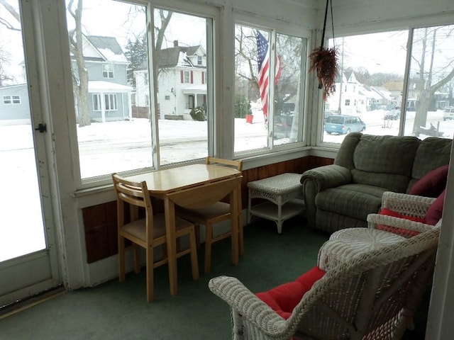 sunroom / solarium with a healthy amount of sunlight and a residential view