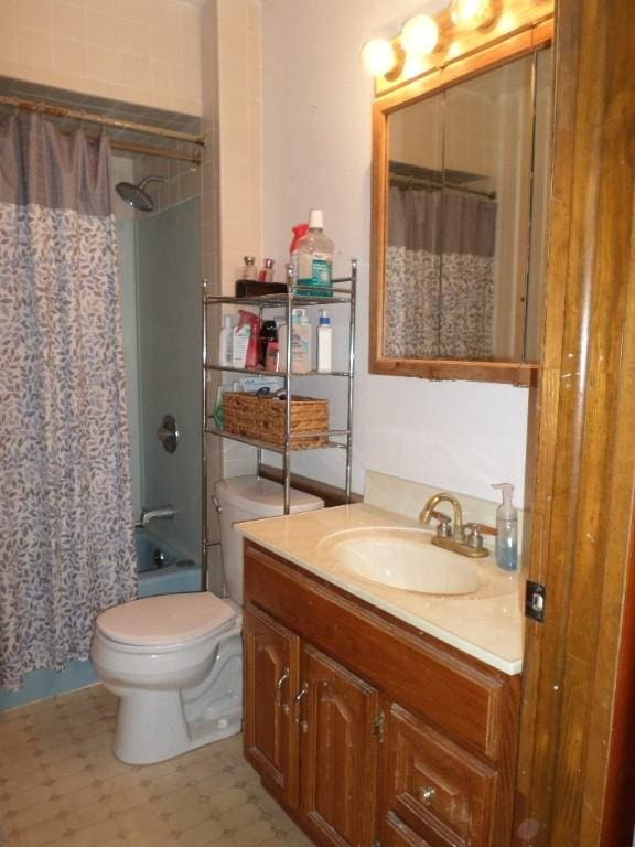 bathroom with toilet, tile patterned floors, shower / tub combo with curtain, and vanity