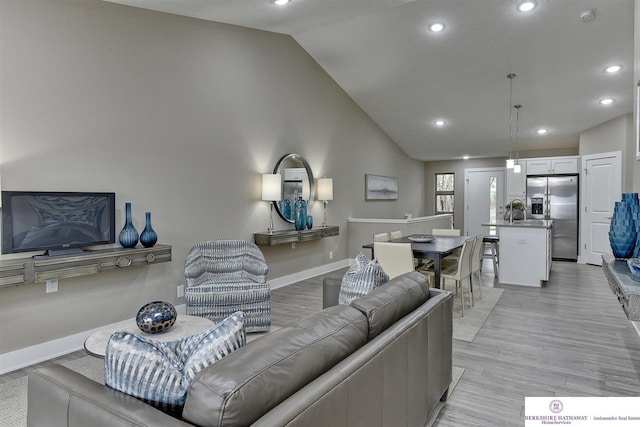 living room with lofted ceiling and light wood-type flooring